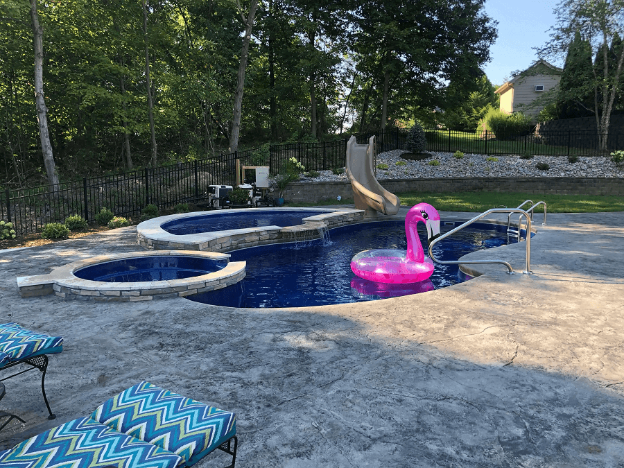 Overhead of dark blue pool and spa with flamingo floatie